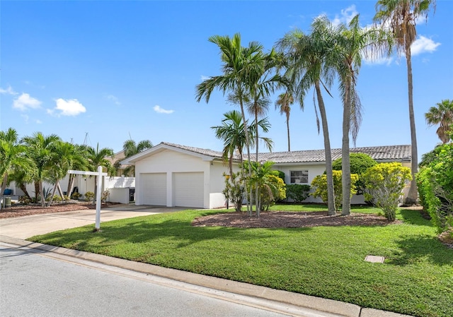 single story home featuring a garage and a front lawn