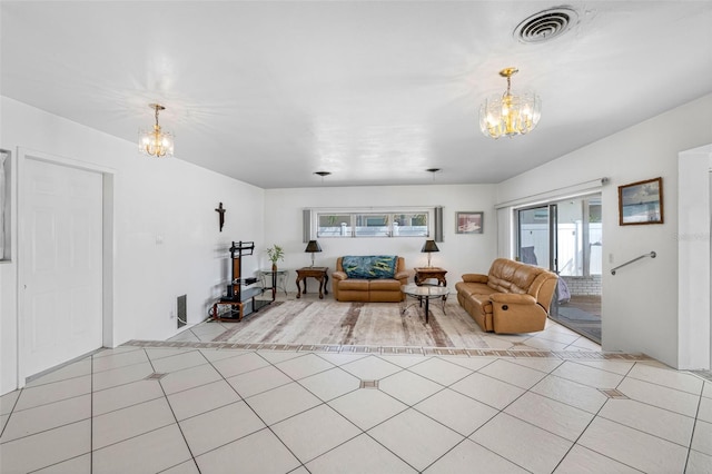 tiled living room featuring a healthy amount of sunlight and a notable chandelier