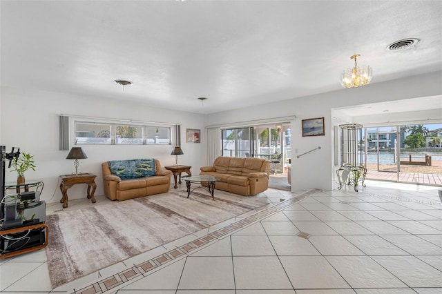 tiled living room featuring an inviting chandelier