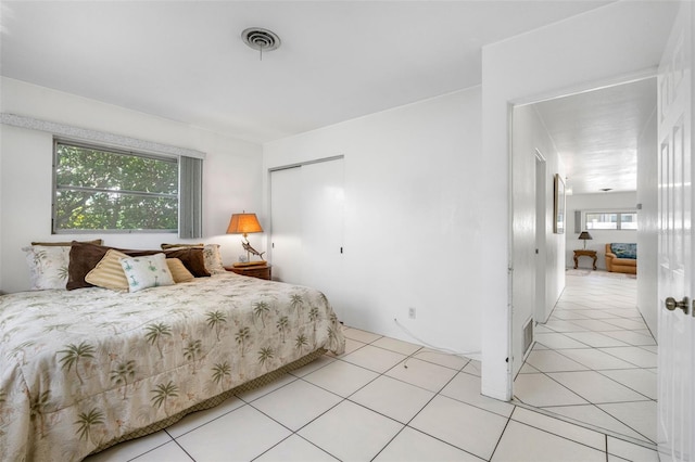 tiled bedroom featuring a closet