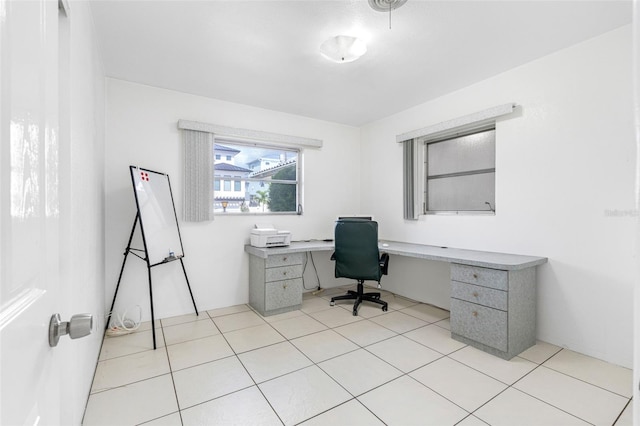 office space featuring built in desk and light tile patterned flooring