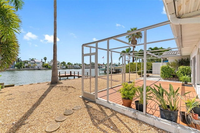 view of yard featuring a dock and a water view