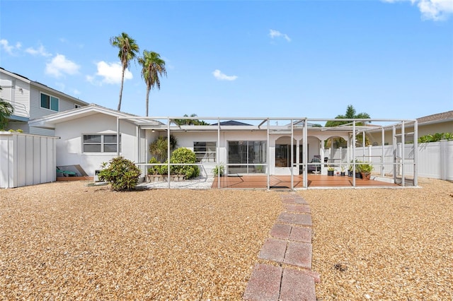 rear view of property with a lanai and a patio area