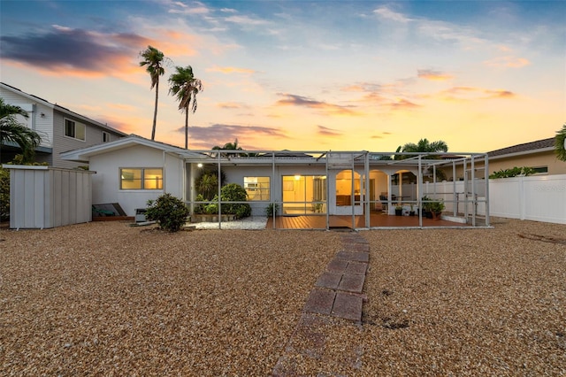 back house at dusk with a patio area