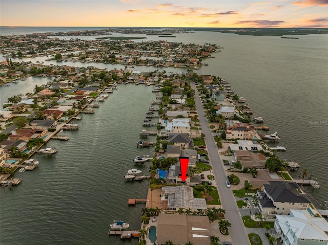 aerial view at dusk with a water view