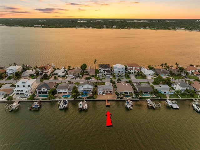 aerial view at dusk with a water view