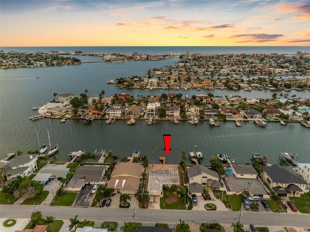 aerial view at dusk with a water view