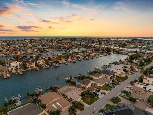 aerial view at dusk with a water view