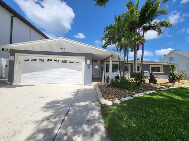 3912 Fontainebleau Dr, Tampa, FL 33634 - ranch-style house with a garage, a porch, and concrete driveway