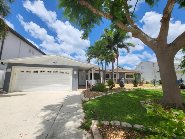 view of front of house featuring a front yard and a garage