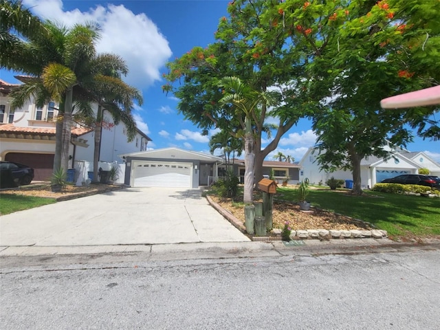 3912 Fontainebleau Dr, Tampa, FL 33634 - view of front of home featuring concrete driveway, a front lawn, and a garage