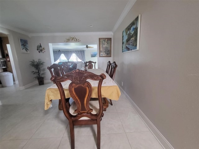 dining room featuring crown molding and light tile patterned flooring