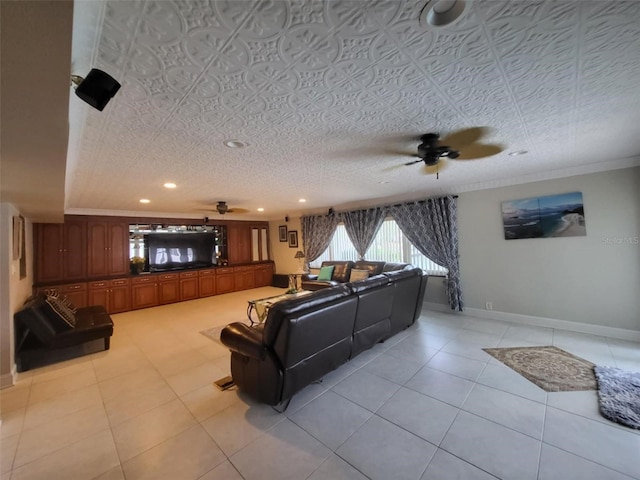 tiled living room featuring a textured ceiling, ceiling fan, and crown molding