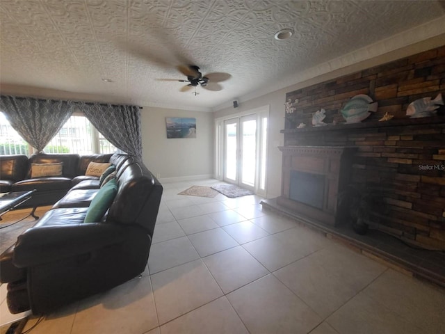 tiled living room with ceiling fan and a textured ceiling