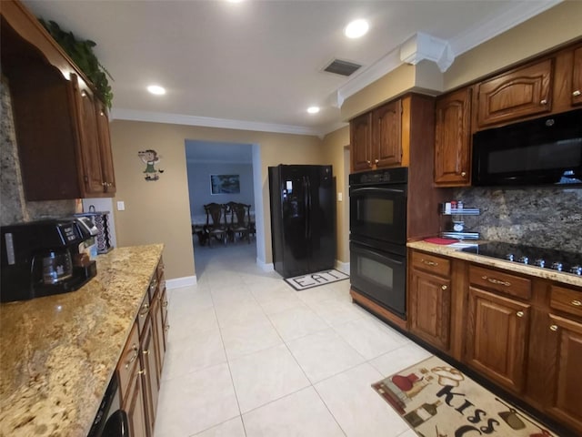 kitchen featuring ornamental molding, tasteful backsplash, light stone counters, black appliances, and light tile patterned flooring