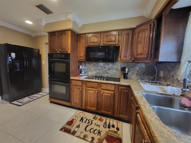 kitchen featuring decorative backsplash, sink, crown molding, black appliances, and light tile patterned floors