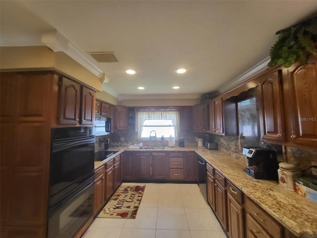 kitchen with sink, light stone counters, decorative backsplash, light tile patterned floors, and black appliances