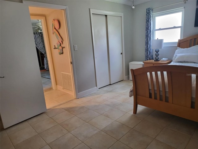 bedroom featuring a closet and light tile patterned floors