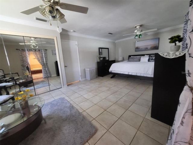 tiled bedroom with a closet, ceiling fan, and crown molding