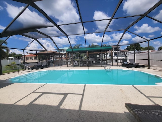 view of pool with a lanai and a patio