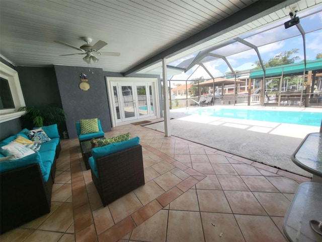 view of patio featuring ceiling fan, glass enclosure, and french doors