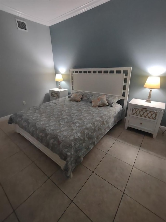 bedroom with tile patterned flooring and crown molding