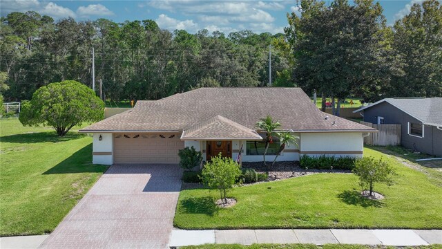 view of front of house with a garage and a front lawn