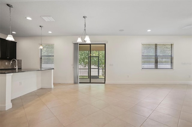 kitchen with visible vents, decorative backsplash, decorative light fixtures, a sink, and recessed lighting