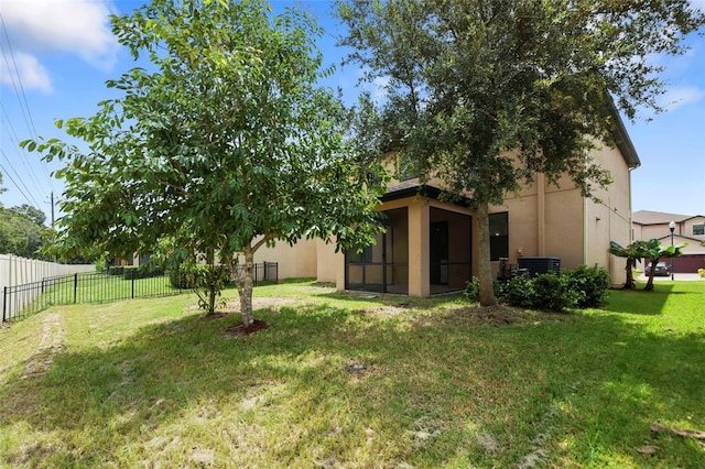 view of yard featuring a fenced backyard and a sunroom