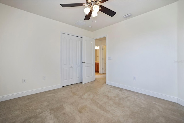 unfurnished bedroom featuring visible vents, light carpet, and baseboards