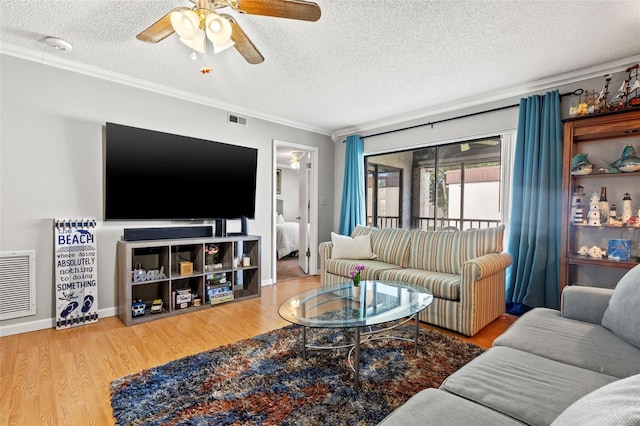 living room featuring a textured ceiling, light hardwood / wood-style flooring, ceiling fan, and ornamental molding