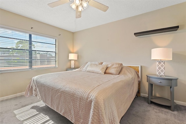 bedroom featuring carpet floors, ceiling fan, and a textured ceiling