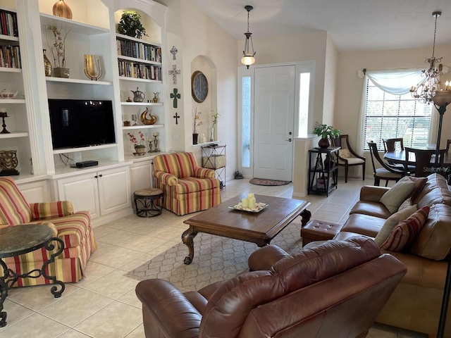 tiled living room with a notable chandelier