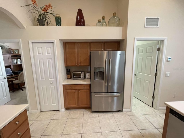 kitchen featuring appliances with stainless steel finishes and light tile patterned floors