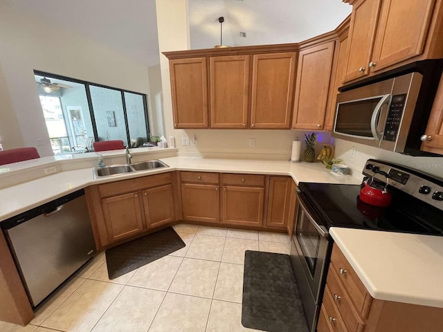 kitchen with ceiling fan, light tile patterned floors, stainless steel appliances, and sink