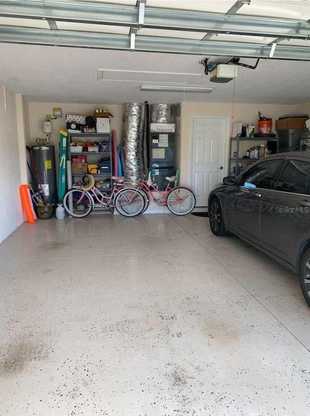 garage featuring water heater and a garage door opener