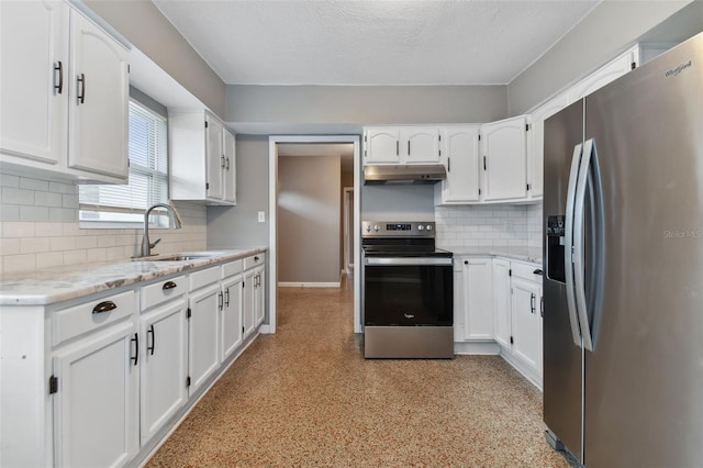 kitchen featuring appliances with stainless steel finishes, white cabinets, sink, and tasteful backsplash