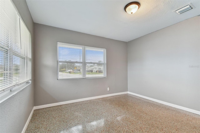 empty room with a textured ceiling