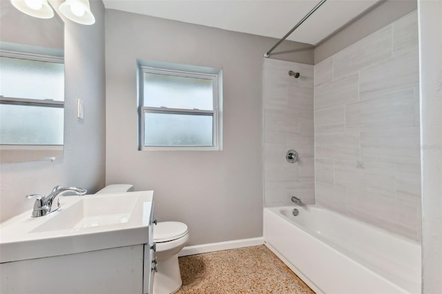 full bathroom featuring tiled shower / bath combo, toilet, and vanity