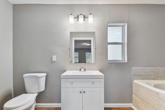 bathroom featuring hardwood / wood-style floors, a bathtub, toilet, and vanity