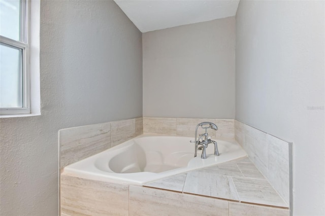 bathroom with tiled bath