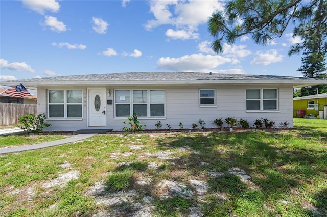 ranch-style home with a front lawn