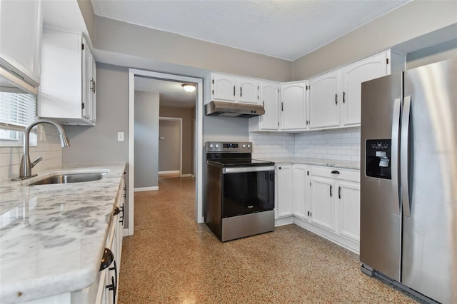 kitchen with appliances with stainless steel finishes, sink, tasteful backsplash, and white cabinets