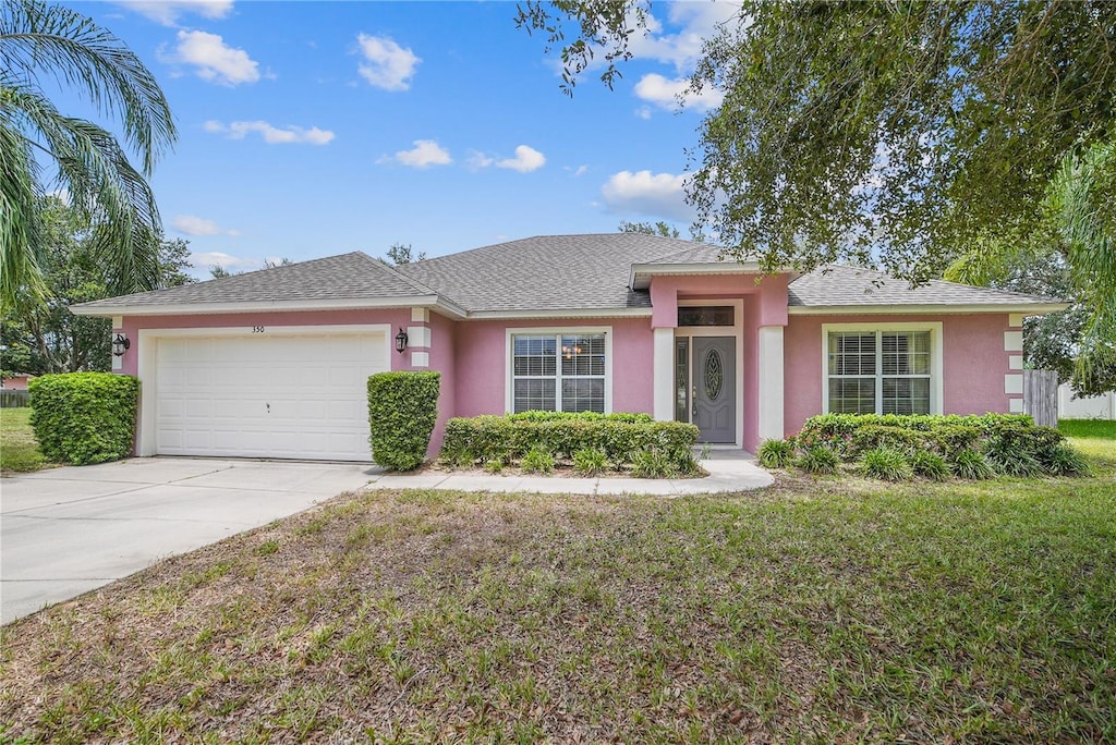 ranch-style home with a front yard and a garage