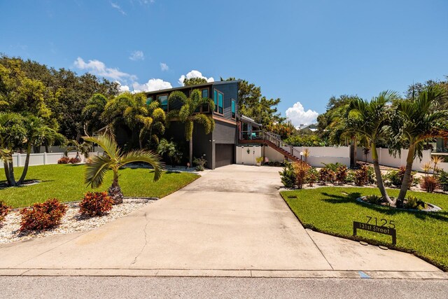 view of front of property with a garage and a front lawn