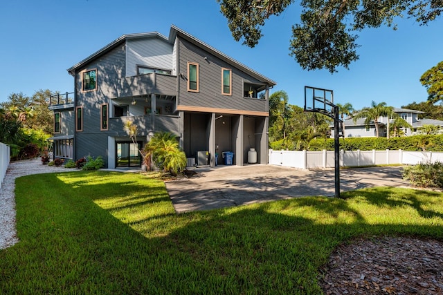 exterior space featuring a yard, a balcony, and a patio