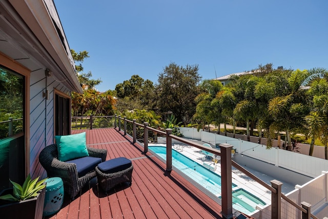 wooden terrace with a fenced in pool