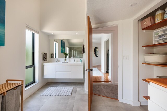 bathroom featuring a textured ceiling and vanity