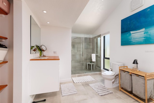 bathroom with a wealth of natural light, vaulted ceiling, toilet, and walk in shower