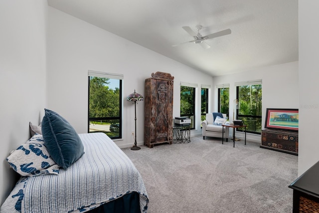 bedroom with ceiling fan, carpet floors, and vaulted ceiling